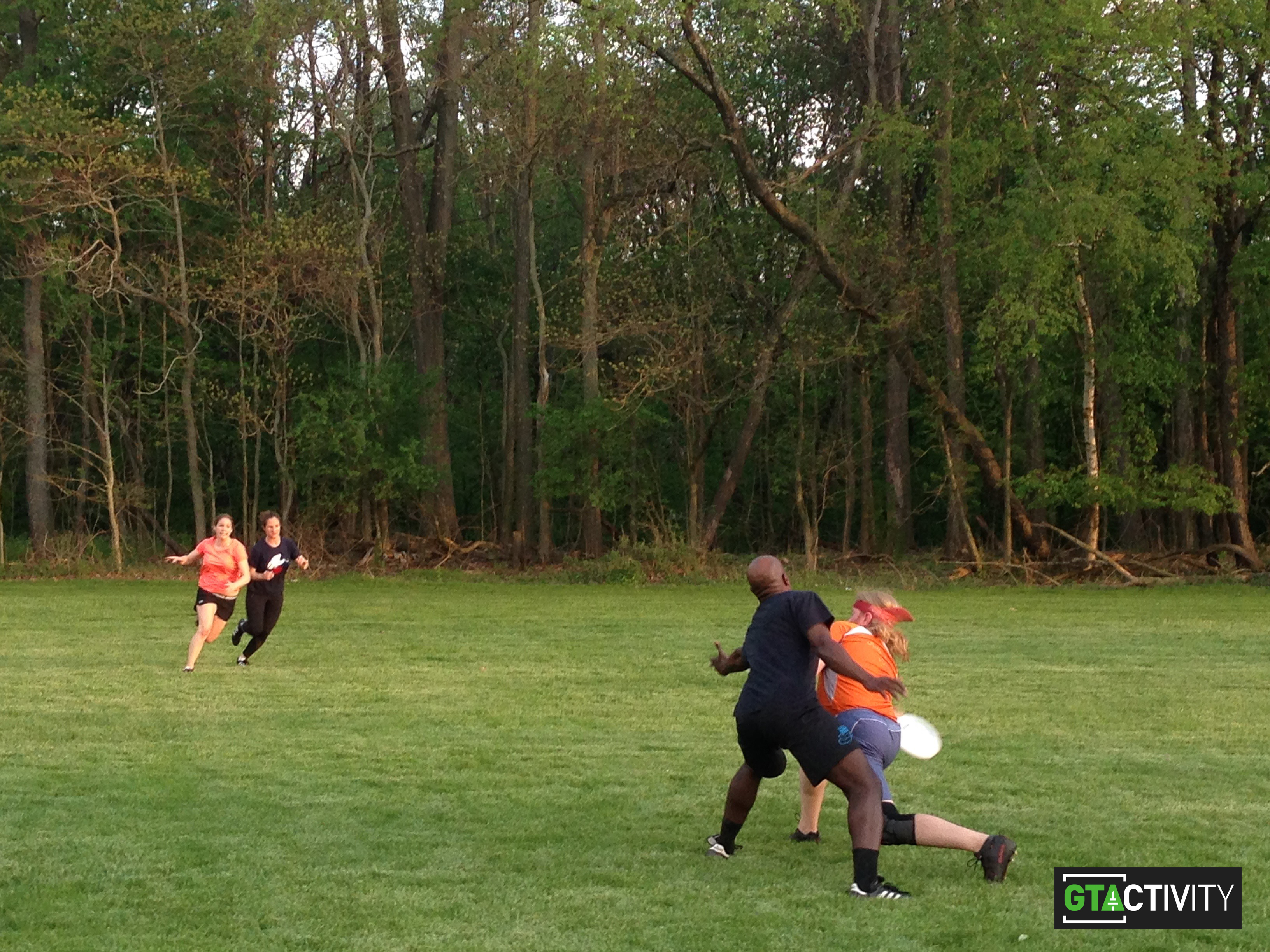 Two men jump to catch a disc in a game of Ultimate.